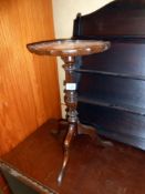 A dark wood tripod side table with leather insert top height 51cm