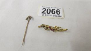 A 9ct gold brooch and an un-marked stick pin.