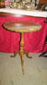 A mahogany pie crust edge tripod table.