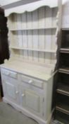 A 20th century painted pine open rack dresser with 2 doors and 2 drawers.