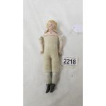 A 19th century porcelain doll with cloth body, 18 cm.