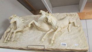 A 3D plaque featuring 4 horses.