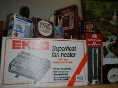 A mixed lot of boxed items including clock, fan heater etc.