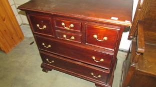 A 20th century mahogany chest of drawers with unusual configuration to drawers.