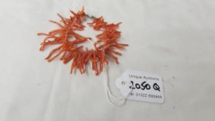 A coral bracelet (missing stone from clasp).