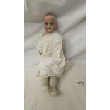 A 19th century porcelain headed doll marked A2/OM, Floradora, AM, missing wig, 44 cm.