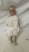 A 19th century porcelain headed doll marked A2/OM, Floradora, AM, missing wig, 44 cm.