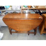 A 1930's oak gate leg table height 75cm, closed 113cm x 40cm,