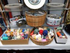 A quantity of haberdashery with a sewing basket including a large quantity of threads and buttons