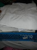 A quantity of white bed linen.