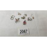 Seven silver charms, approximately 22 grams.