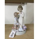 A Lladro figure group of a boy and girl with toys, 21 cm tall (a/f to boys finger).