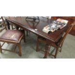 A mahogany extending dining table.