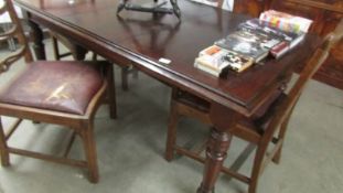 A mahogany extending dining table.