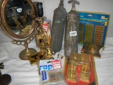 A fantastic oval brass mirror, 2 brass fire extinguishers, a brass lamp and other items.