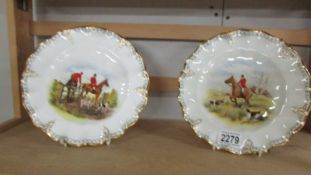 A pair of Royal Crown derby plates hand painted with hunting scenes.