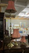 A brass standard lamp and 2 brass table lamps.