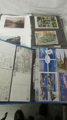 2 albums of assorted postcards.