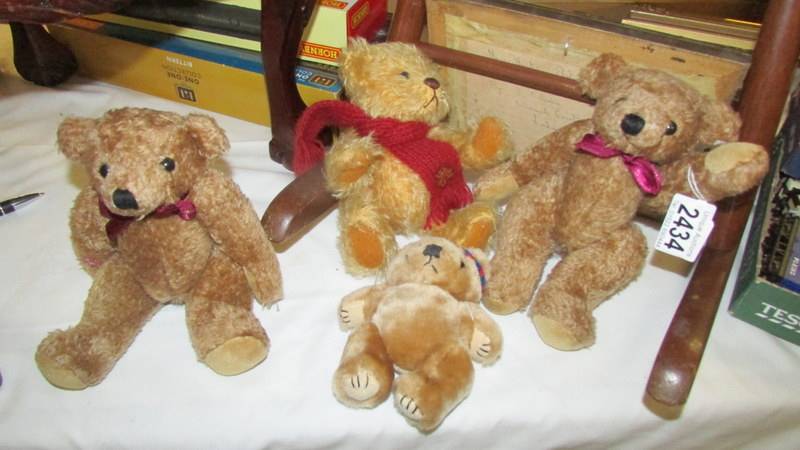 Four small teddy bears.