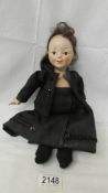 A vintage doll in black costume, 36 cm, a/f.