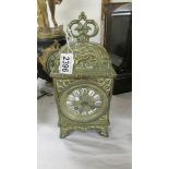 A heavy brass 8 day mantel clock (glass cracked).