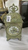 A heavy brass 8 day mantel clock (glass cracked).