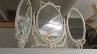 An oval French style triple dressing table mirror.