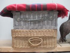 2 wicker picnic baskets and a picnic blanket