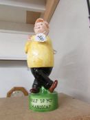 An advertising figural decanter "Golf is my Sport", 30 cm tall, in good condition.