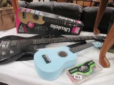 An Encore electric guitar and a boxed pure tune Ukelele in blue plus quantity of picks