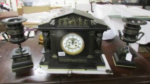 A 3 piece Edwardian black slate clock garniture with side urns, Benetfink & Co.