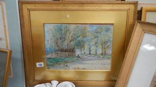 A gilt framed and glazed watercolour woodland scene with sheep.