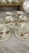An 18 piece English bone pheasant decorated tea set