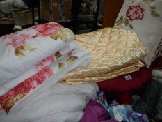 A quantity of quilts, cushions etc.