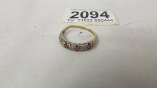 A 9ct yellow gold garnet and diamond ring, size Q.