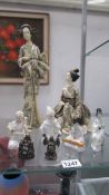 A selection of oriental figures including porcelain, tall resin figure etc.