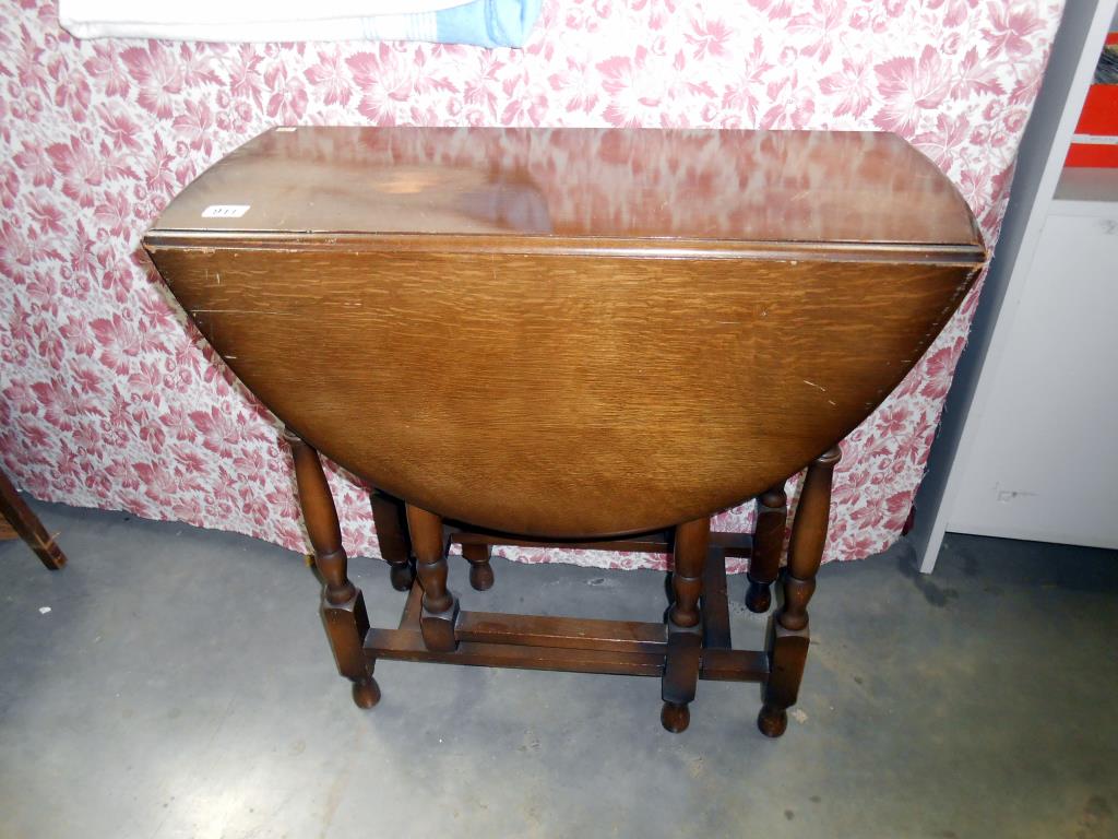 A 1930's oak gateleg table 77cm x 34cm x height 73cm,