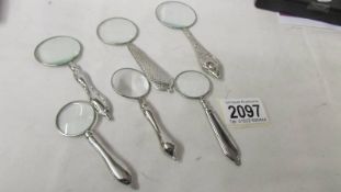 6 assorted silver plated magnifying glasses.