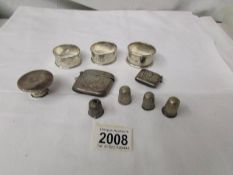 A mixed lot of silver items including 3 silver napkin rings, 4 thimbles, a vesta etc.