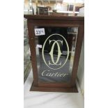 A small glazed wood display case 'Cartier'.