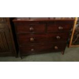 A two over two mahogany chest of drawers.