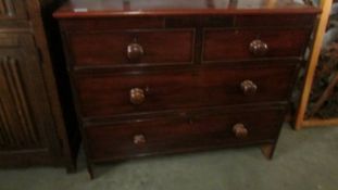 A two over two mahogany chest of drawers.