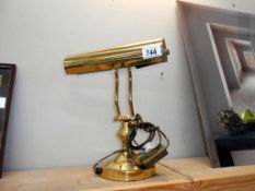 A brass effect bankers table lamp