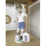 A Lladro boy footballer figure.