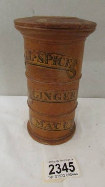 A three part turned wood spice storage drum, 15 cm tall.