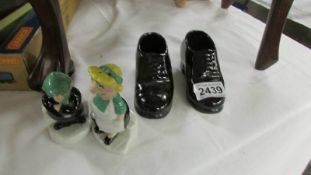 an Andy Capp and Flo salt and pepper together with a pair of ceramic shoes.