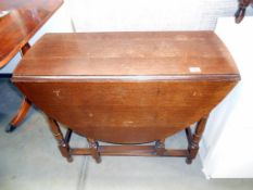 An oak gateleg table Height 73cm,