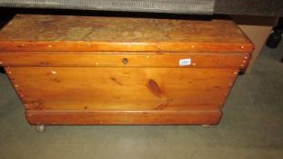 A pine blanket box on castors.