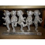 A silver- coloured teddy bear group