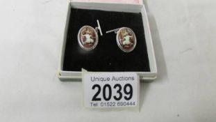 A pair of sterling silver 'What the Butler Saw' cuff links.